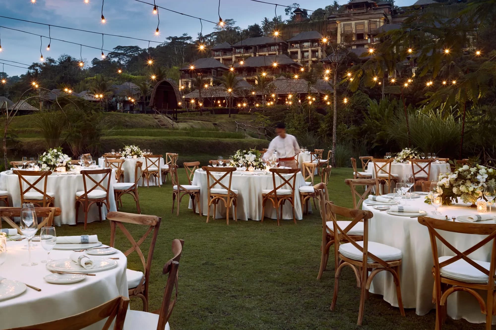 Temple Lawn reception dinner set up under greenery at Mandapa a Ritz-Carlton Reserve Ubud Bali