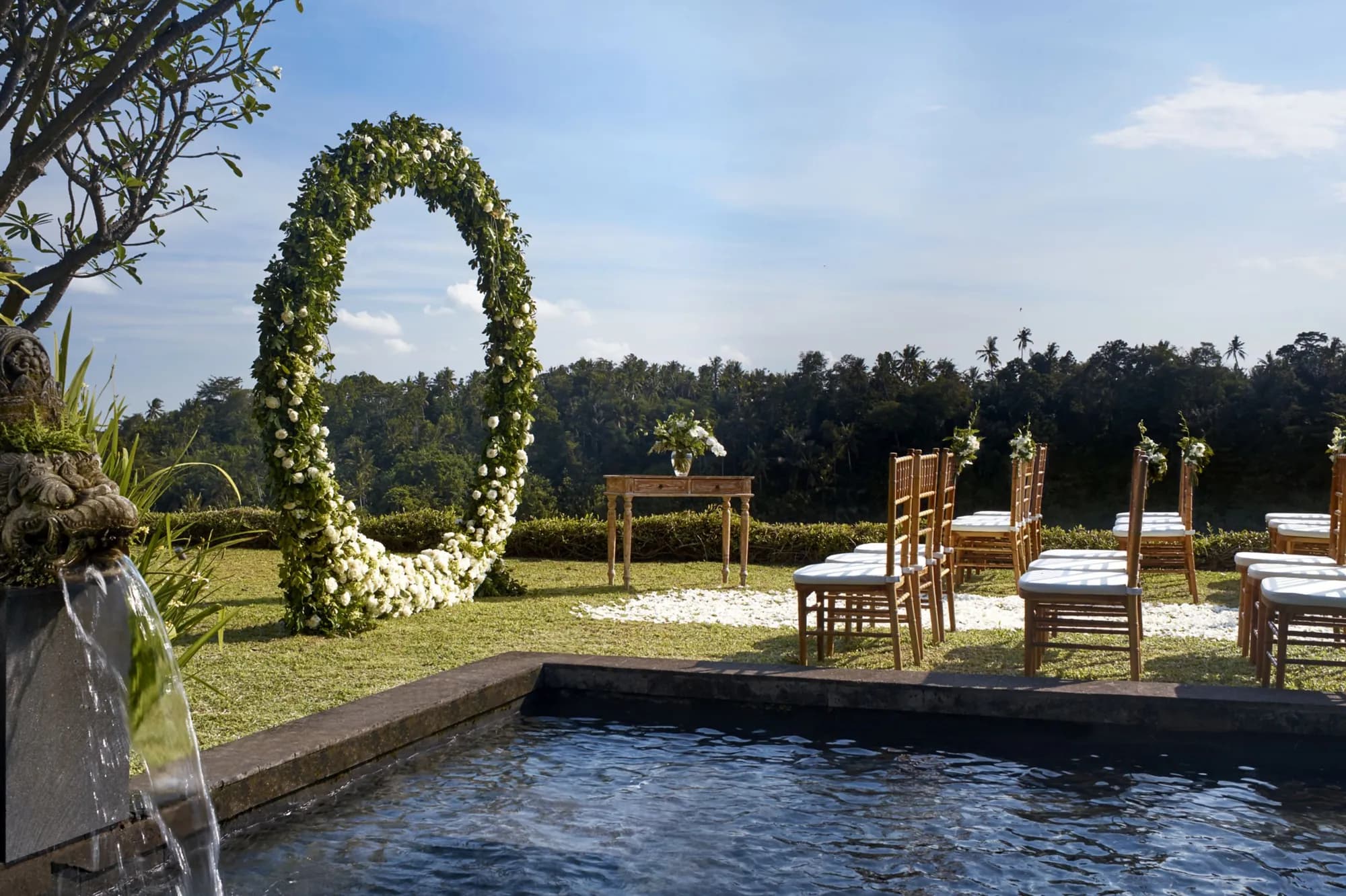 Mandapa a Ritz-Carlton Reserve lit up in the green Ayung River valley at dusk near Ubud Bali
