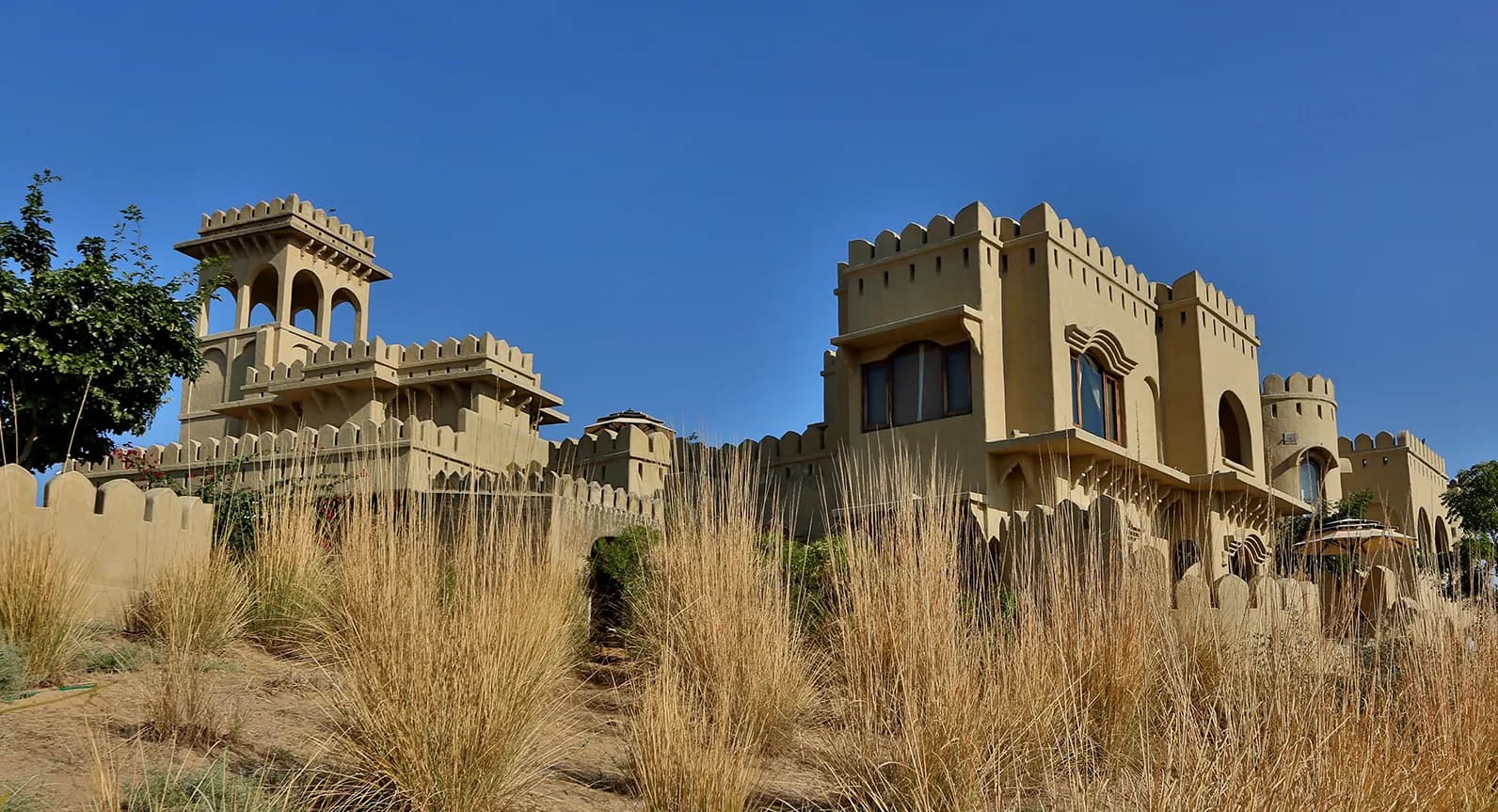 Mihir Garh mud-and-timber desert fort exterior on a dune in the Thar Desert near Jodhpur