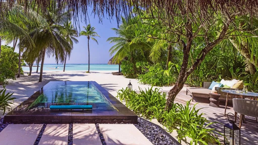 One&Only Reethi Rah beach villa private pool opening onto a white-sand beach, ceremony setting Maldives