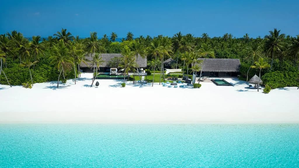 One&Only Reethi Rah private island and over-water villas on the lagoon at golden hour, North Male Atoll Maldives