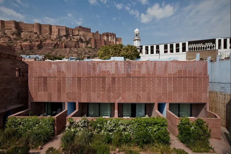RAAS Jodhpur sandstone haveli architecture with Mehrangarh Fort rising behind it