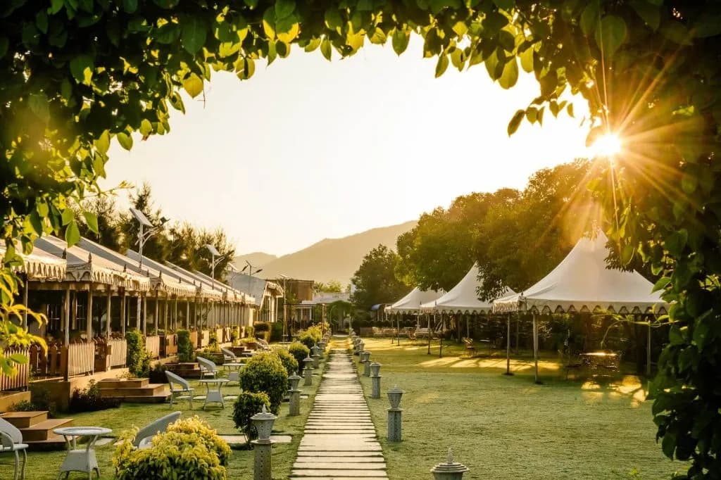 Rawai Luxury Tents Pushkar aerial view of luxury canvas tents and gardens against the Aravalli hills at sunrise