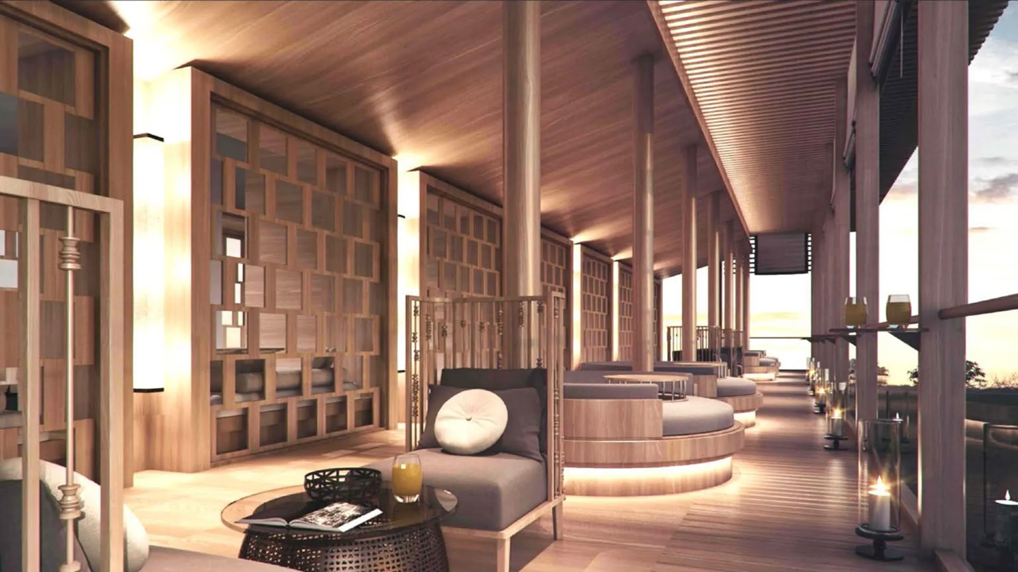 Open-air arrival lounge and lobby terrace at The Ritz-Carlton Koh Samui overlooking the bay at dusk