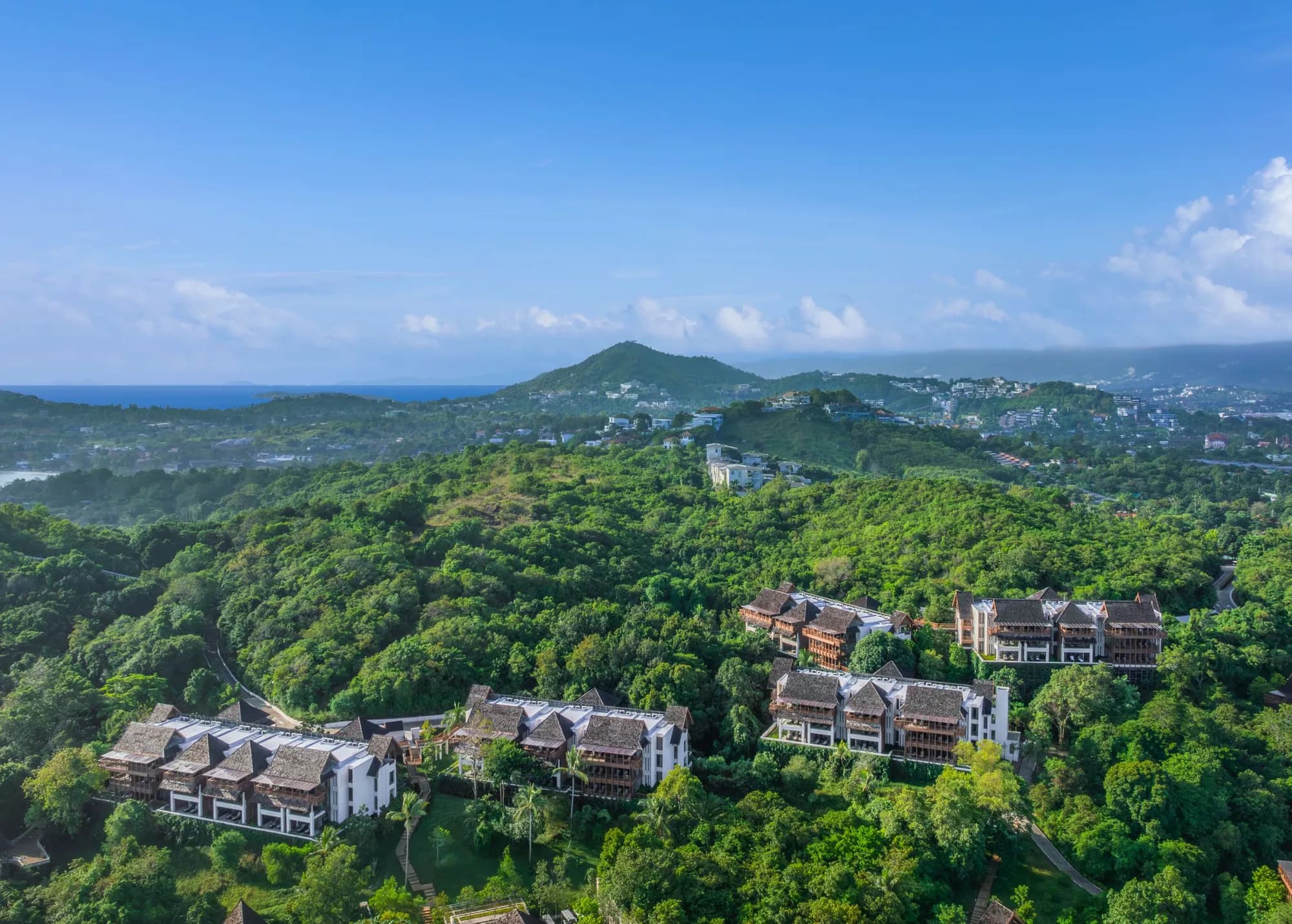 Aerial exterior of The Ritz-Carlton Koh Samui hillside villas in the coconut grove above the Gulf of Thailand