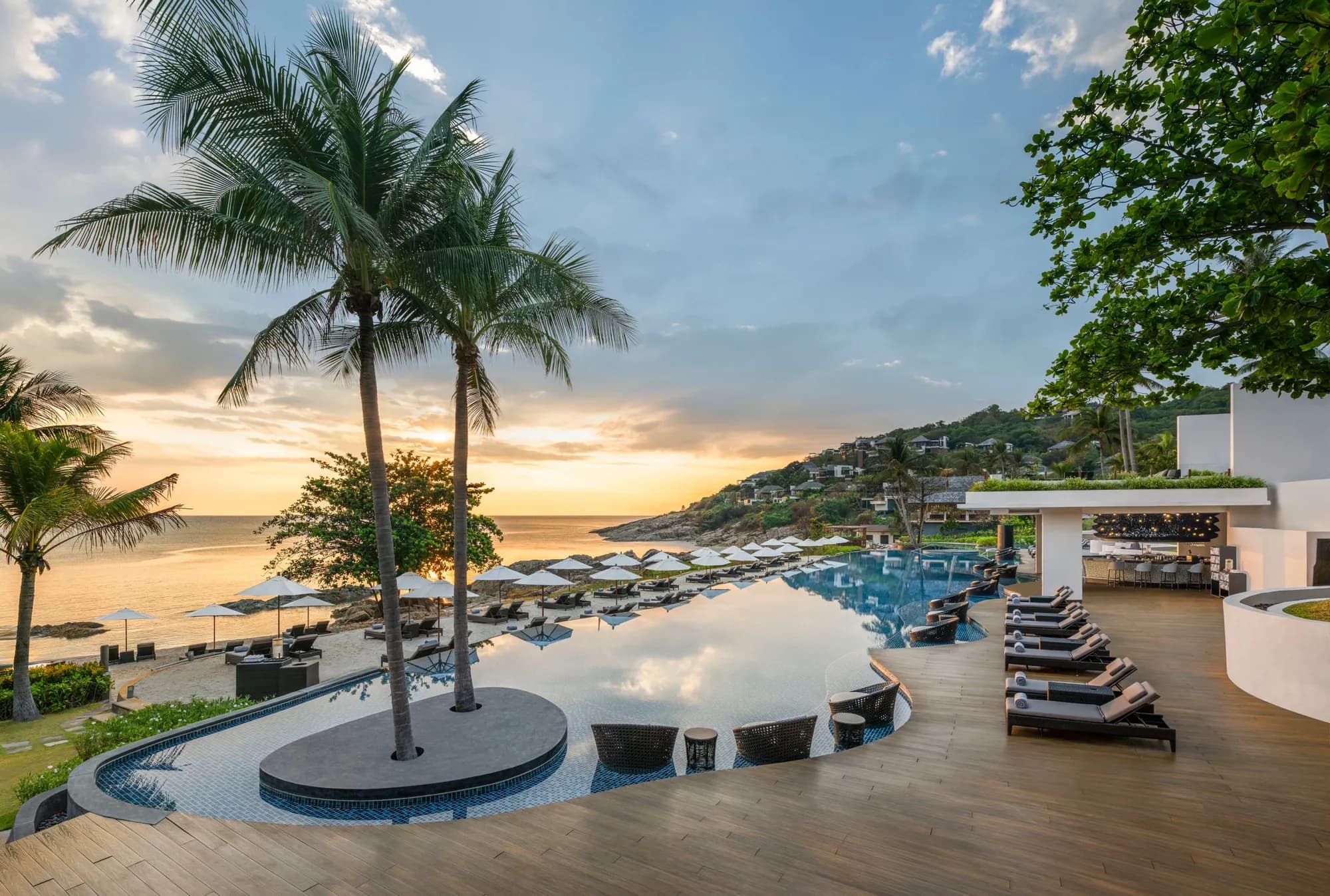 The Ritz-Carlton Koh Samui private bay, infinity pool and palms at golden hour on the Gulf of Thailand