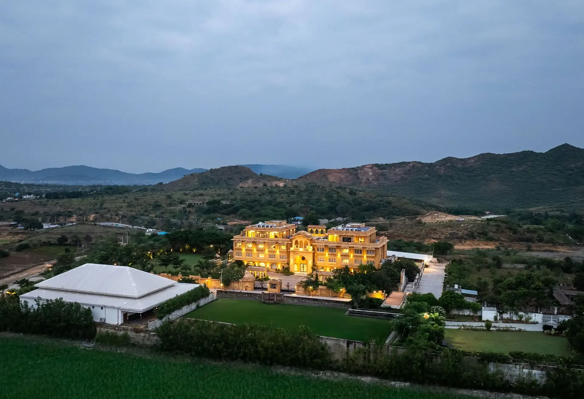 Heritage-style facade and architecture of Sahdev Bagh Pushkar across landscaped gardens