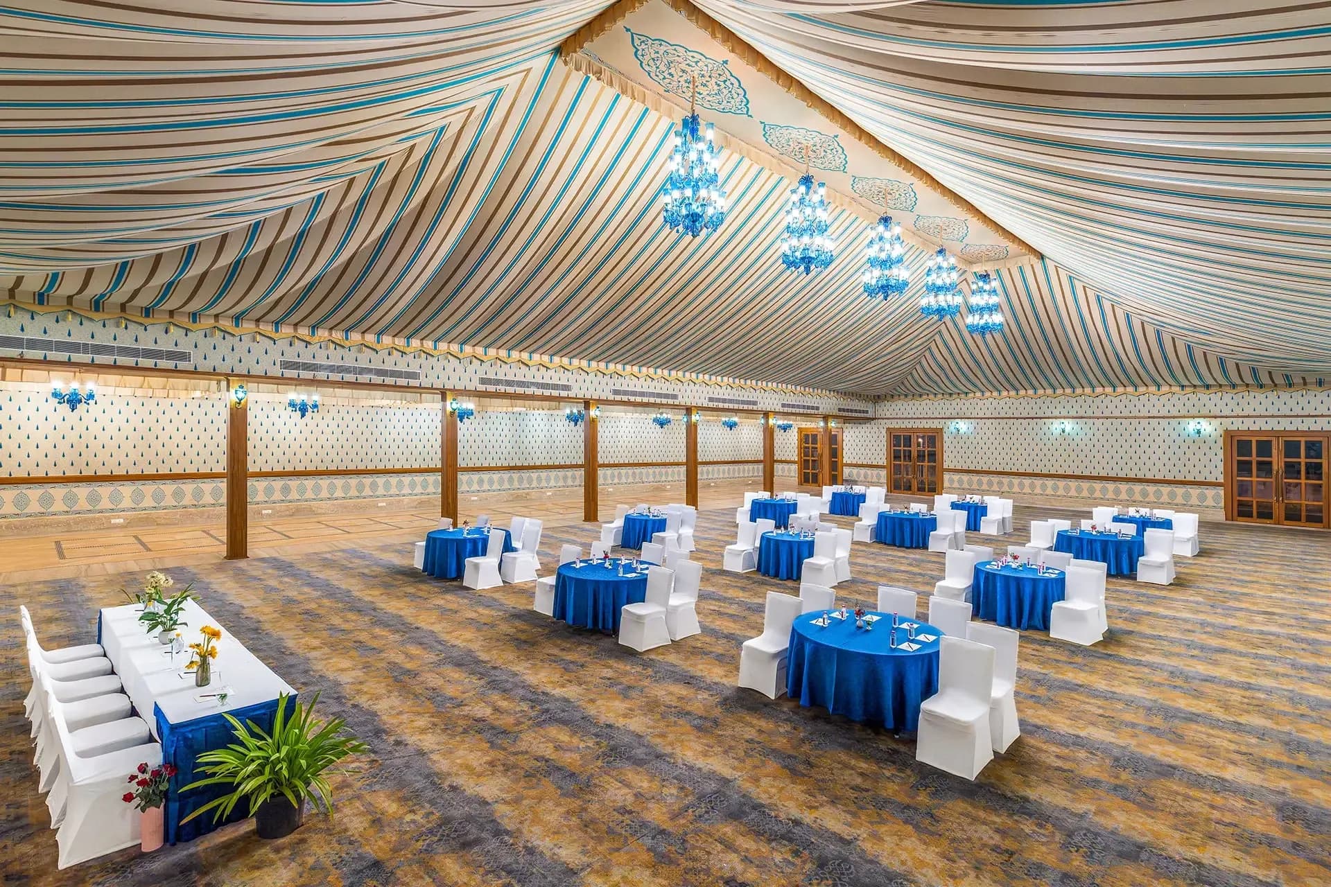 Ghorband indoor banquet hall set for a wedding dinner at Sahdev Bagh Pushkar
