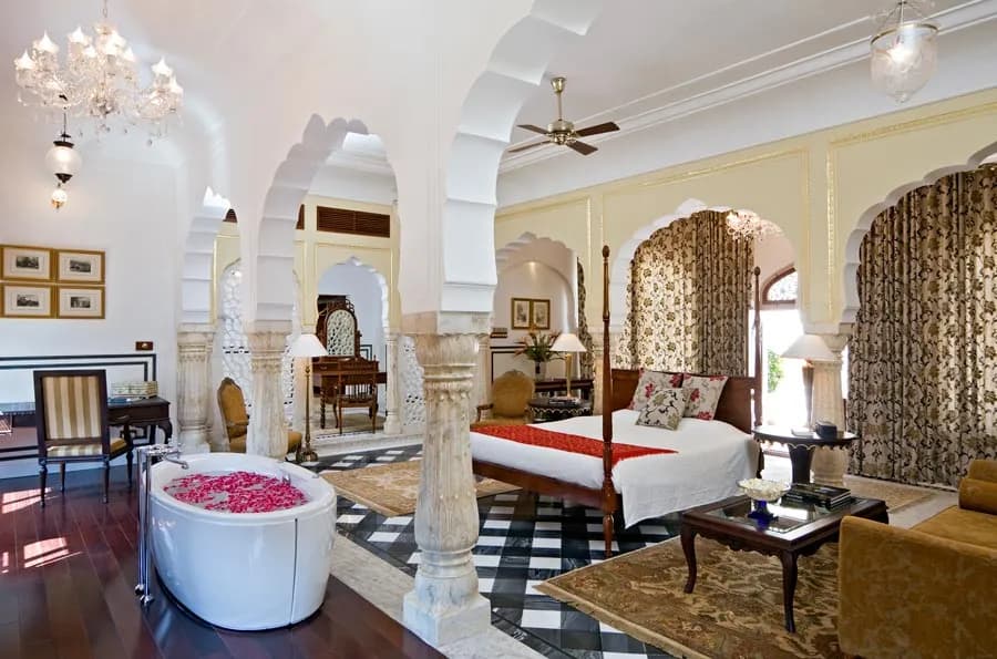 Royal suite with four-poster bed and heritage furnishings at Samode Palace Jaipur