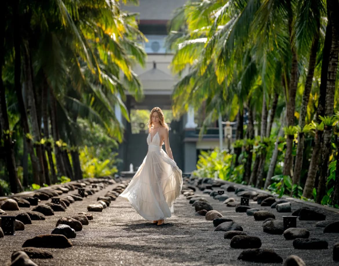 Palm-lined arrival pathway lined with stones leading into The St. Regis Bali Resort, Nusa Dua, Bali