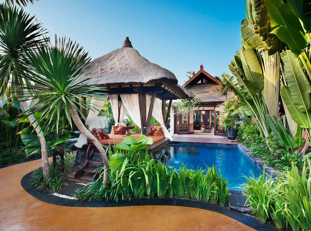 Private villa exterior with thatched gazebo, plunge pool and lush tropical garden at The St. Regis Bali Resort, Nusa Dua