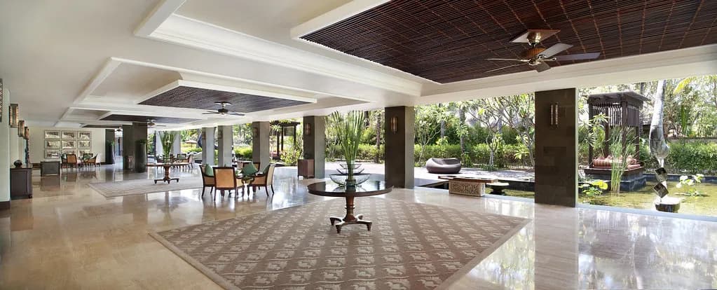 Open Balinese-roofed Astor Ballroom pre-function area with reflecting pool and gardens at The St. Regis Bali Resort, Nusa Dua