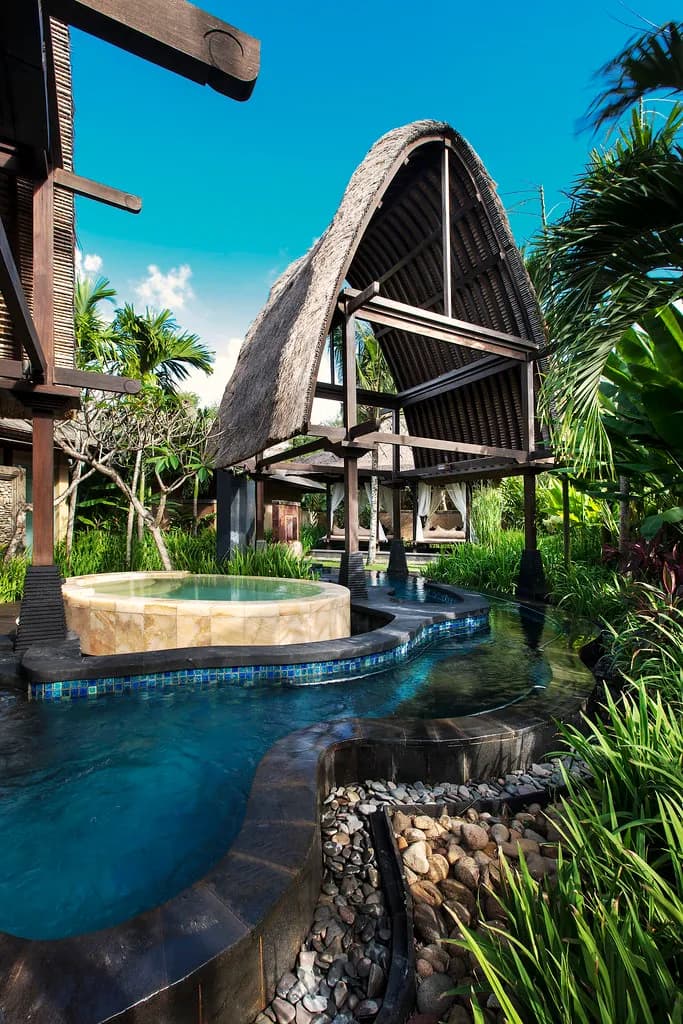The St. Regis Bali Resort saltwater lagoon and Vista Bar pavilion glowing at dusk, Nusa Dua, Bali