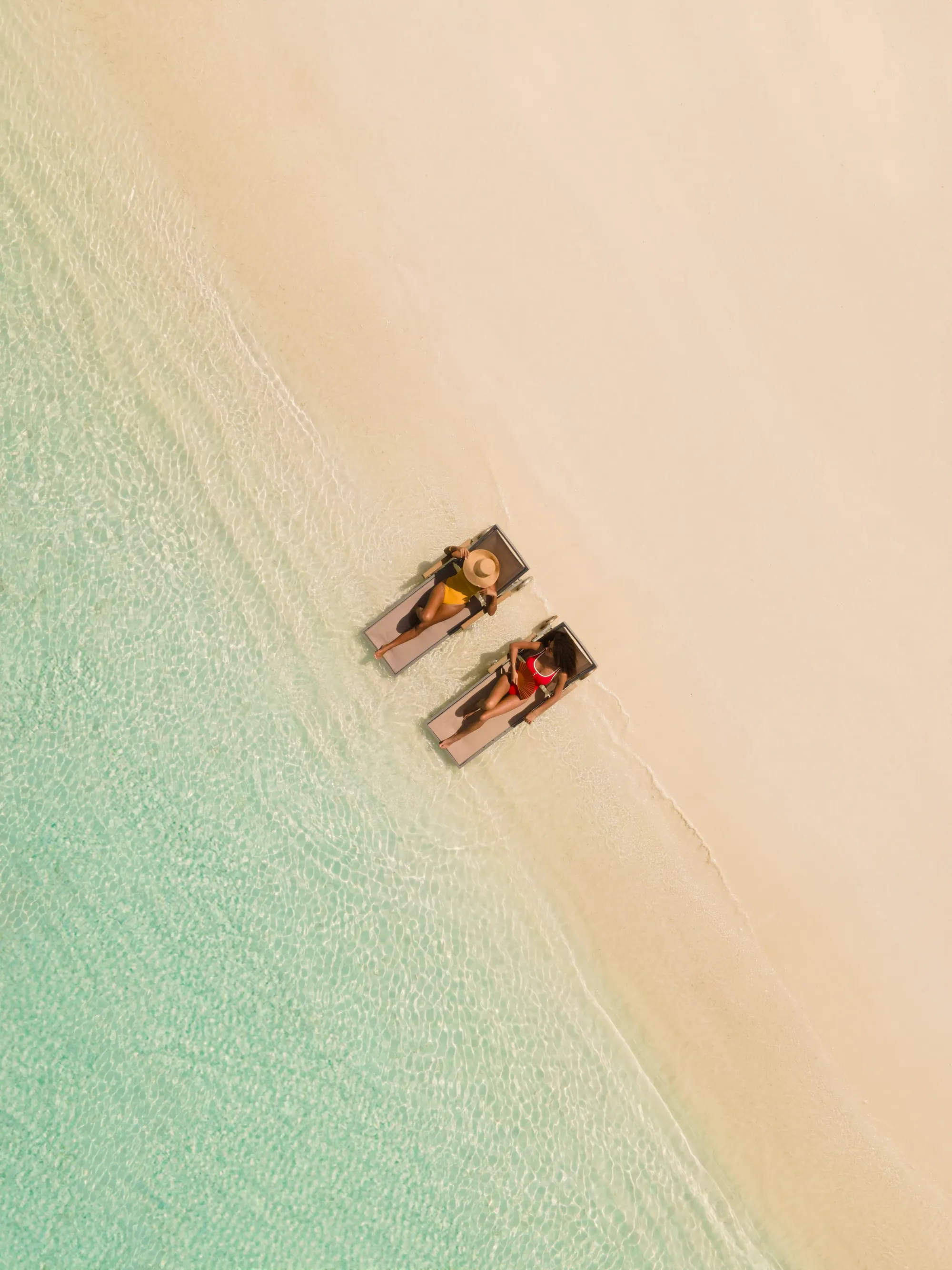 Aerial arrival view of Sun Siyam Iru Fushi island reached by seaplane across the turquoise Noonu Atoll lagoon, Maldives