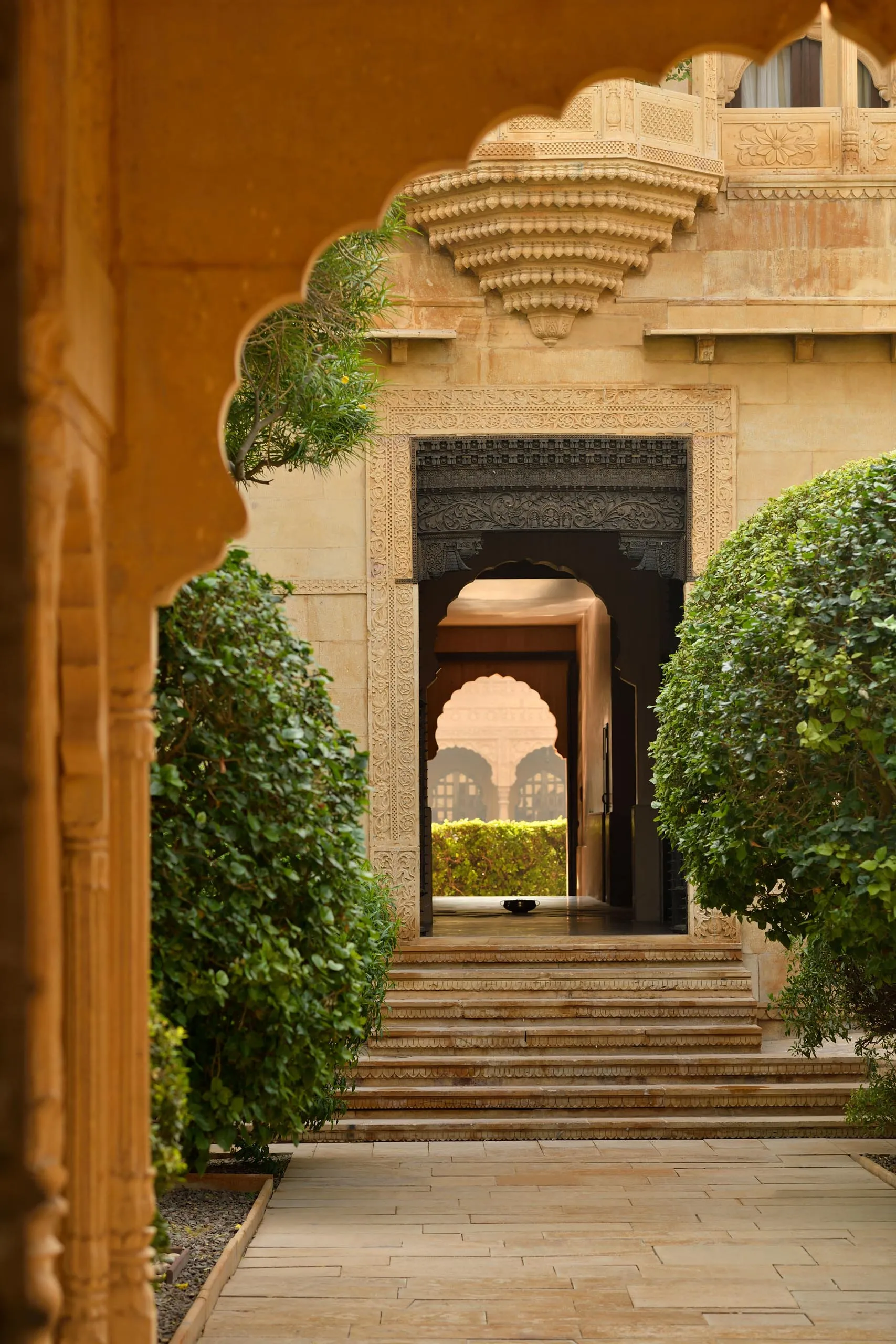 Walled sandstone courtyard set for a banquet dinner at Suryagarh Jaisalmer