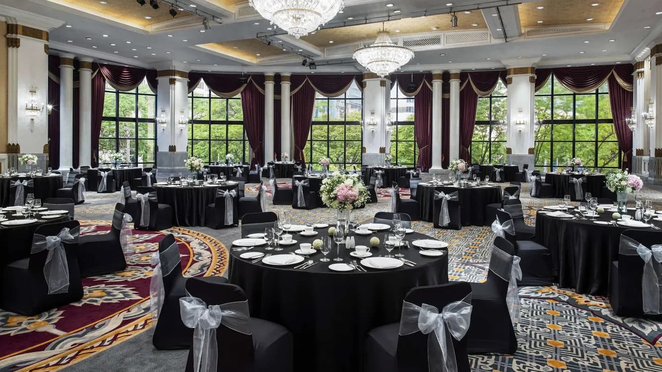 Pillarless ballroom set with round tables for a banquet dinner at The Athenee Hotel Bangkok