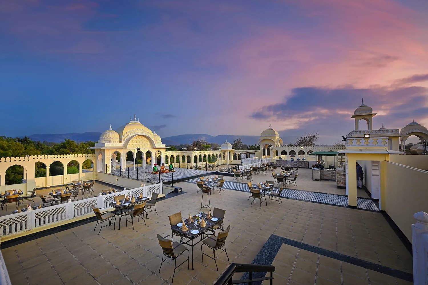 The Tigress heritage-style resort and the Ranthambore wilderness backdrop glowing at dusk
