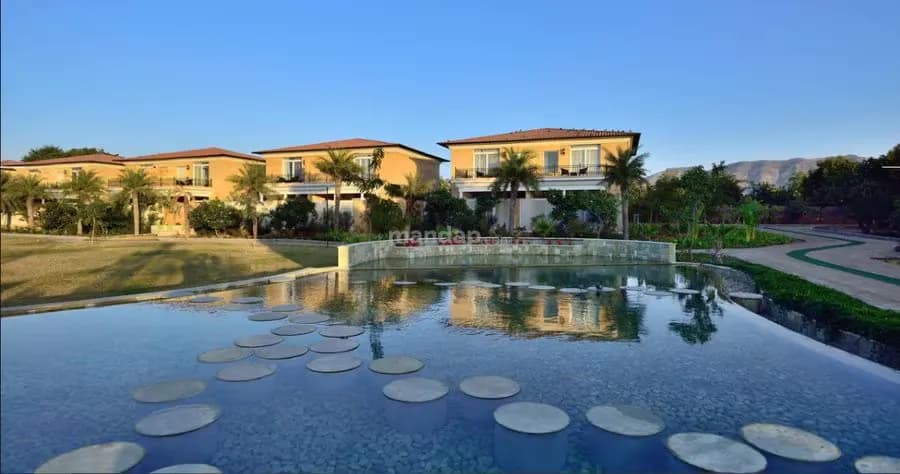 The Westin Pushkar Resort villa blocks and reflecting water feature with the Aravalli hills behind, Pushkar