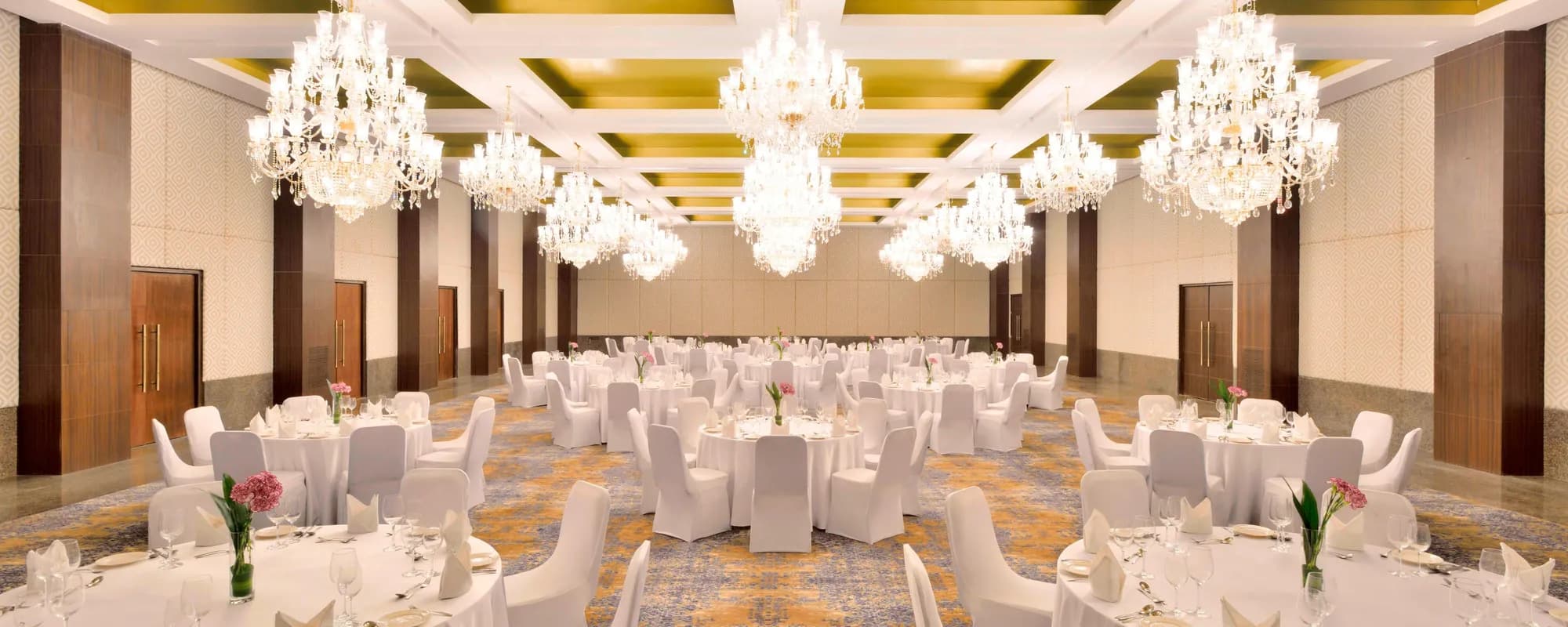 The Royal Ballroom set for a banquet with crystal chandeliers and gold ceiling at The Westin Pushkar Resort & Spa