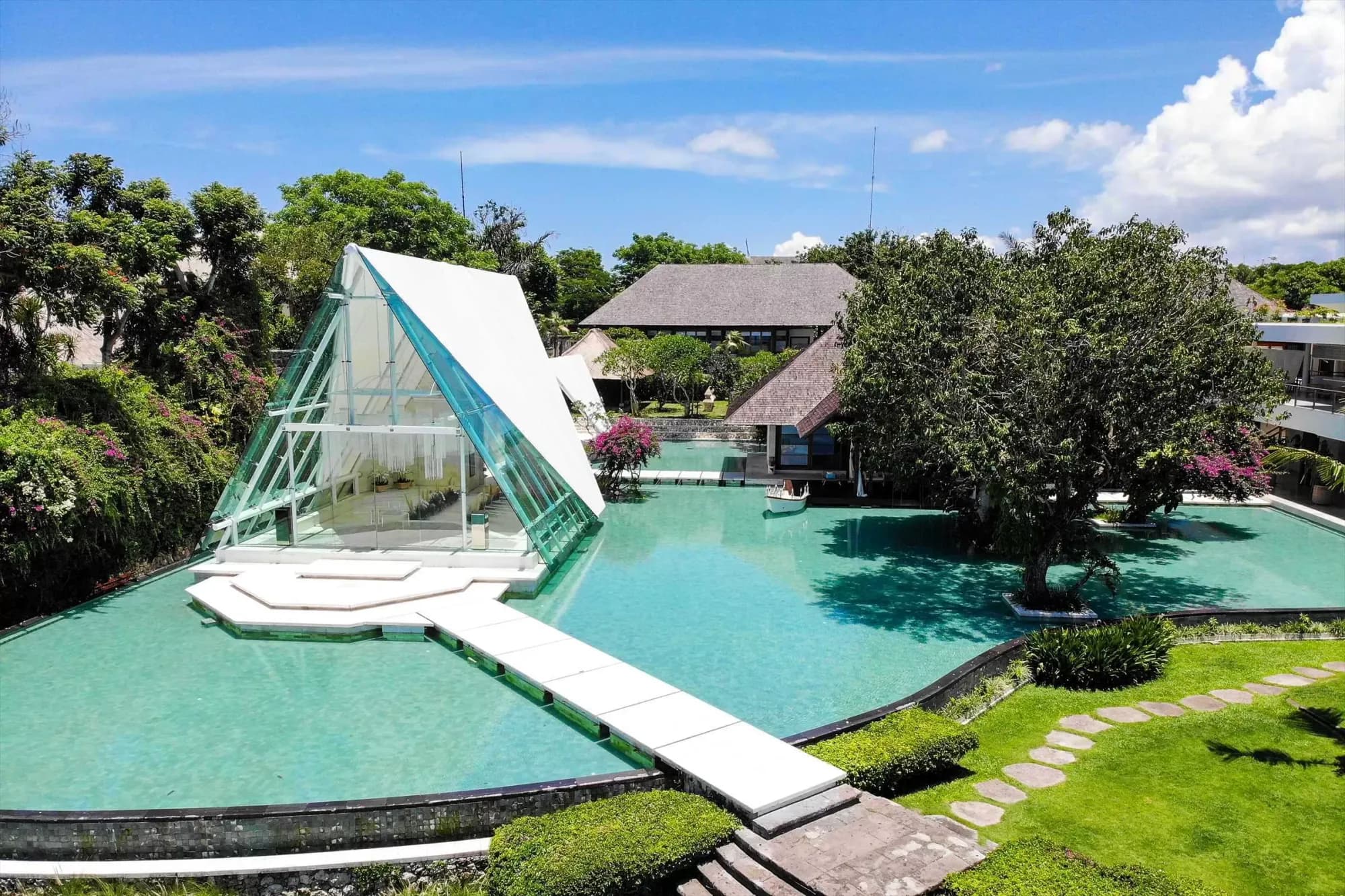 Tirtha Uluwatu clifftop wedding venue with glass chapel and ocean-view terraces above the Indian Ocean in Uluwatu, Bali