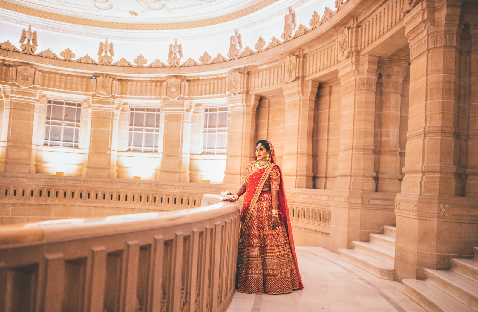 Bride in a sandstone palace colonnade
