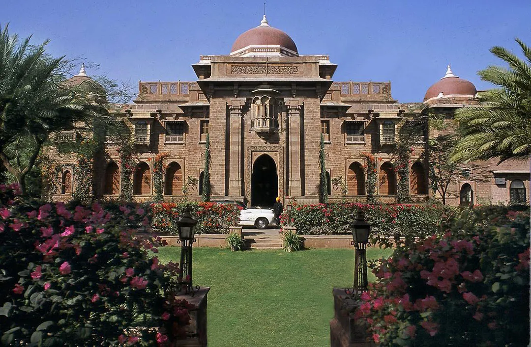 Liveried attendant with silver service and rose detailing at Ajit Bhawan Palace Jodhpur