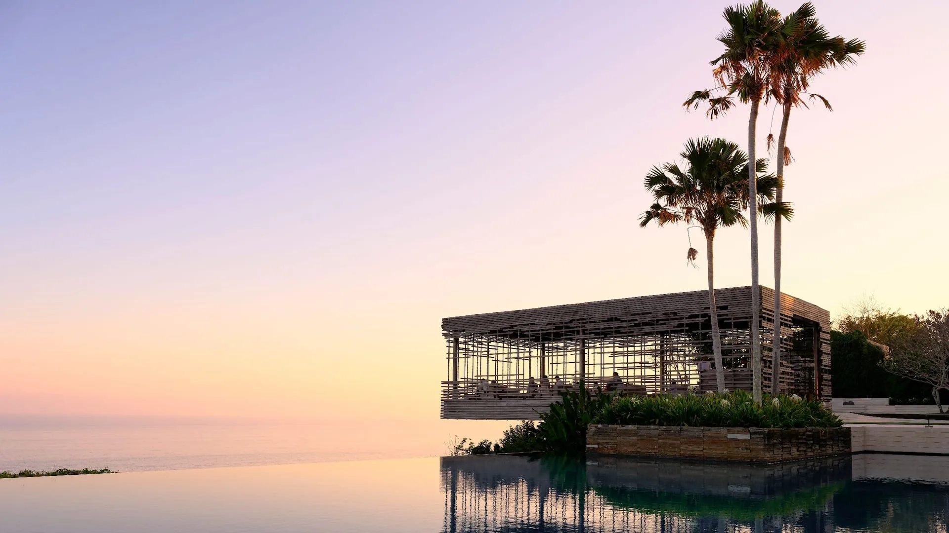 Sunset Cabana and cliff-edge lawn over the Indian Ocean at Alila Villas Uluwatu, Bali