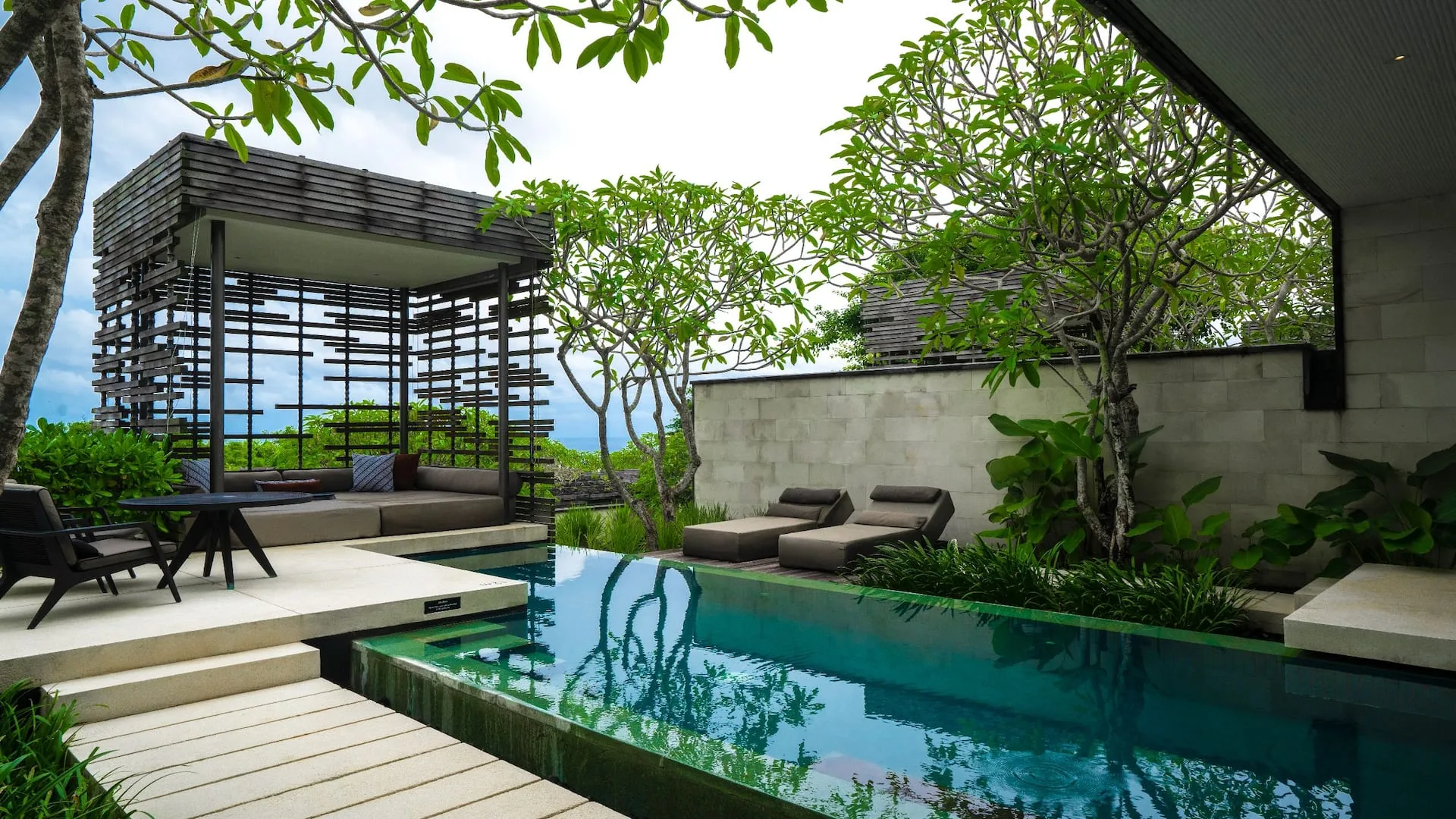 Aerial of Alila Villas Uluwatu clifftop estate at golden hour over the Indian Ocean, Bali