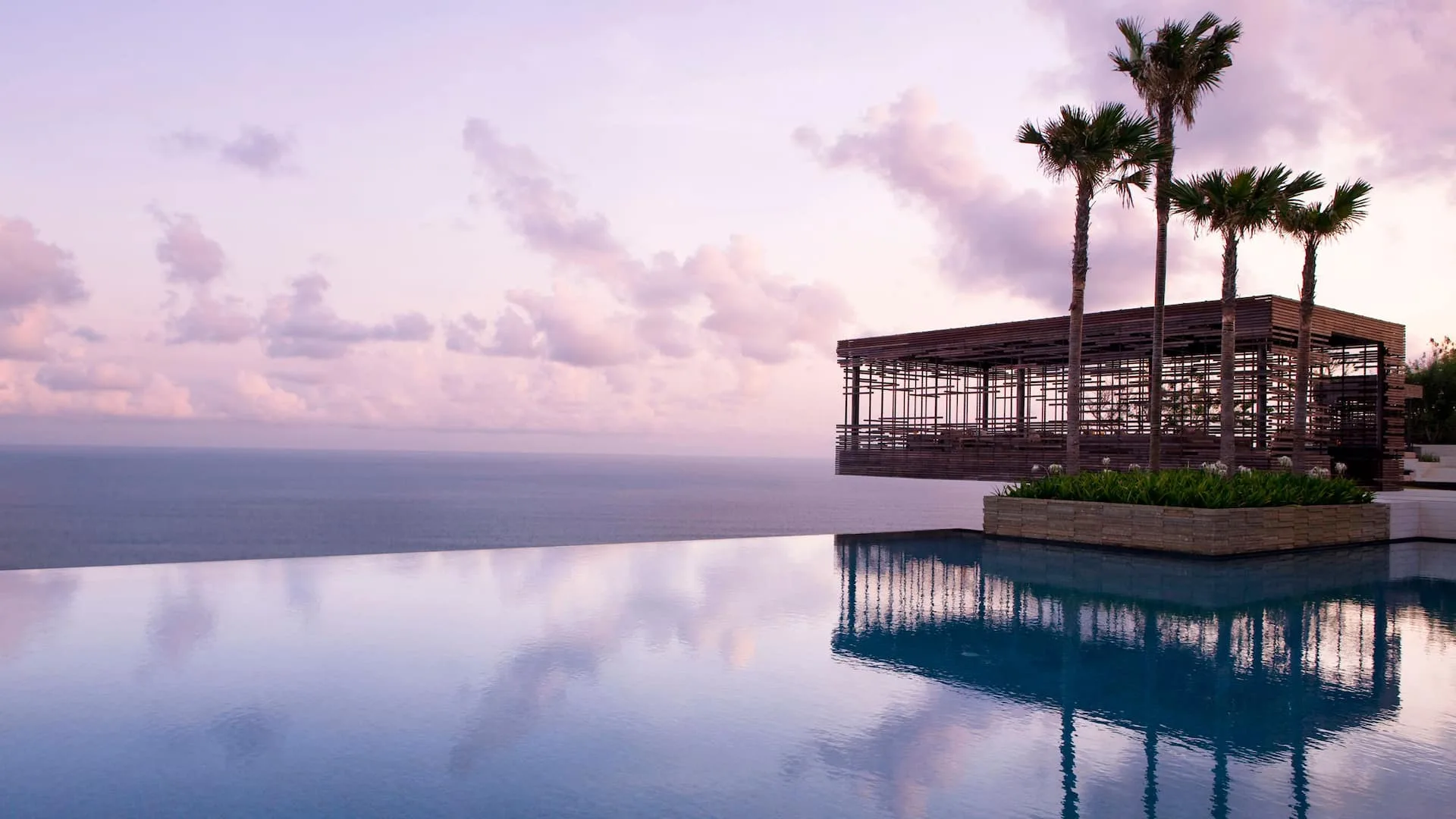 Alila Villas Uluwatu clifftop villa estate and the Indian Ocean glowing at golden hour, Bali