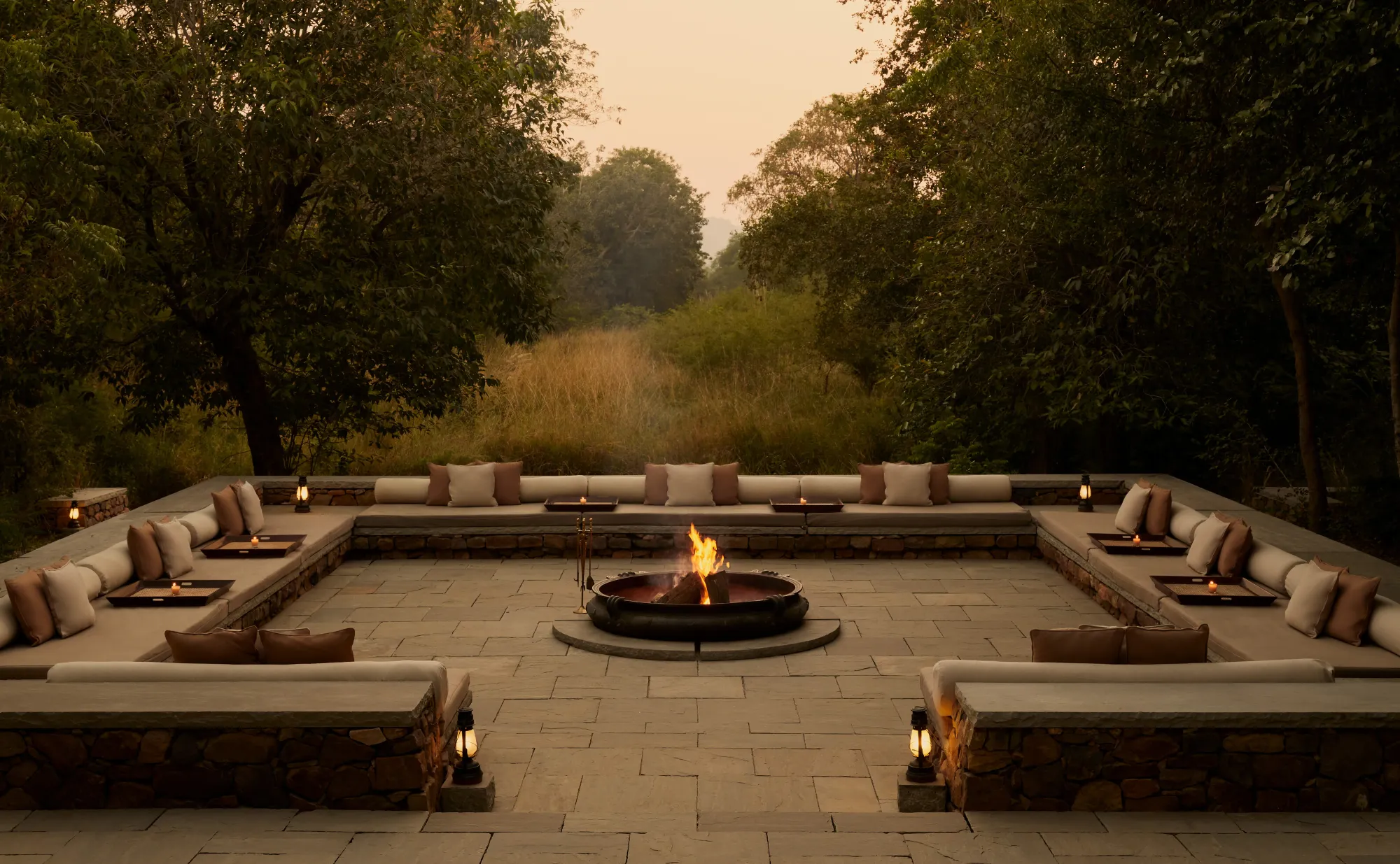Open-sided lounge tent exterior glowing with warm light at dusk at Aman-i-Khas Ranthambore