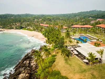 Coconut estate grounds and clifftop arrival approach at Anantara Peace Haven Tangalle Resort, Sri Lanka