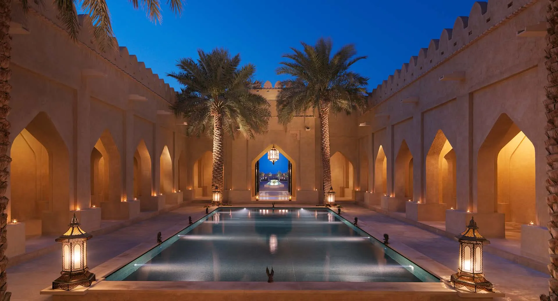 Lantern-lit arrival courtyard of Anantara Qasr Al Sarab Desert Resort at night, Liwa, Abu Dhabi