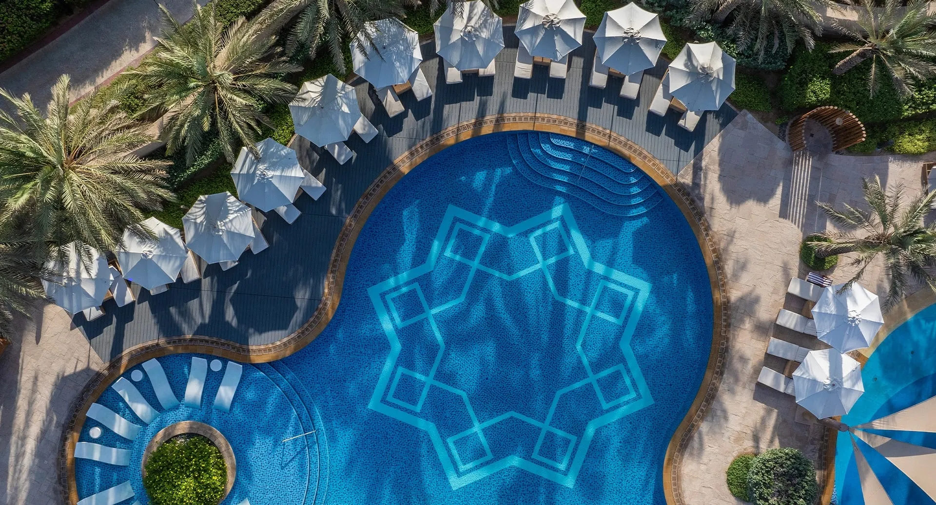 Main infinity pool aerial overlooking the Empty Quarter dunes at Anantara Qasr Al Sarab, Abu Dhabi