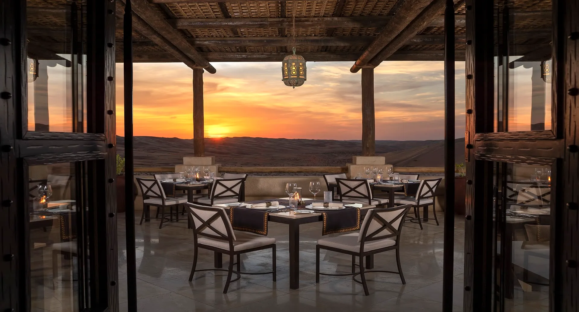Suhail restaurant outdoor terrace dining at sunset above the dunes at Anantara Qasr Al Sarab, Abu Dhabi
