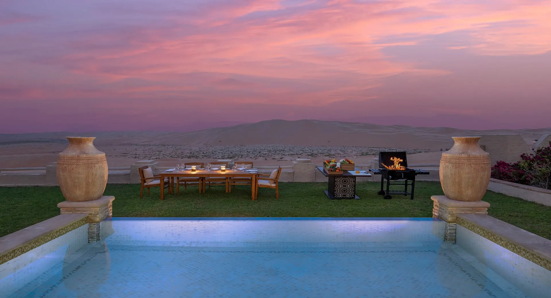 Villa BBQ private dining setup in the desert at twilight at Anantara Qasr Al Sarab, Abu Dhabi