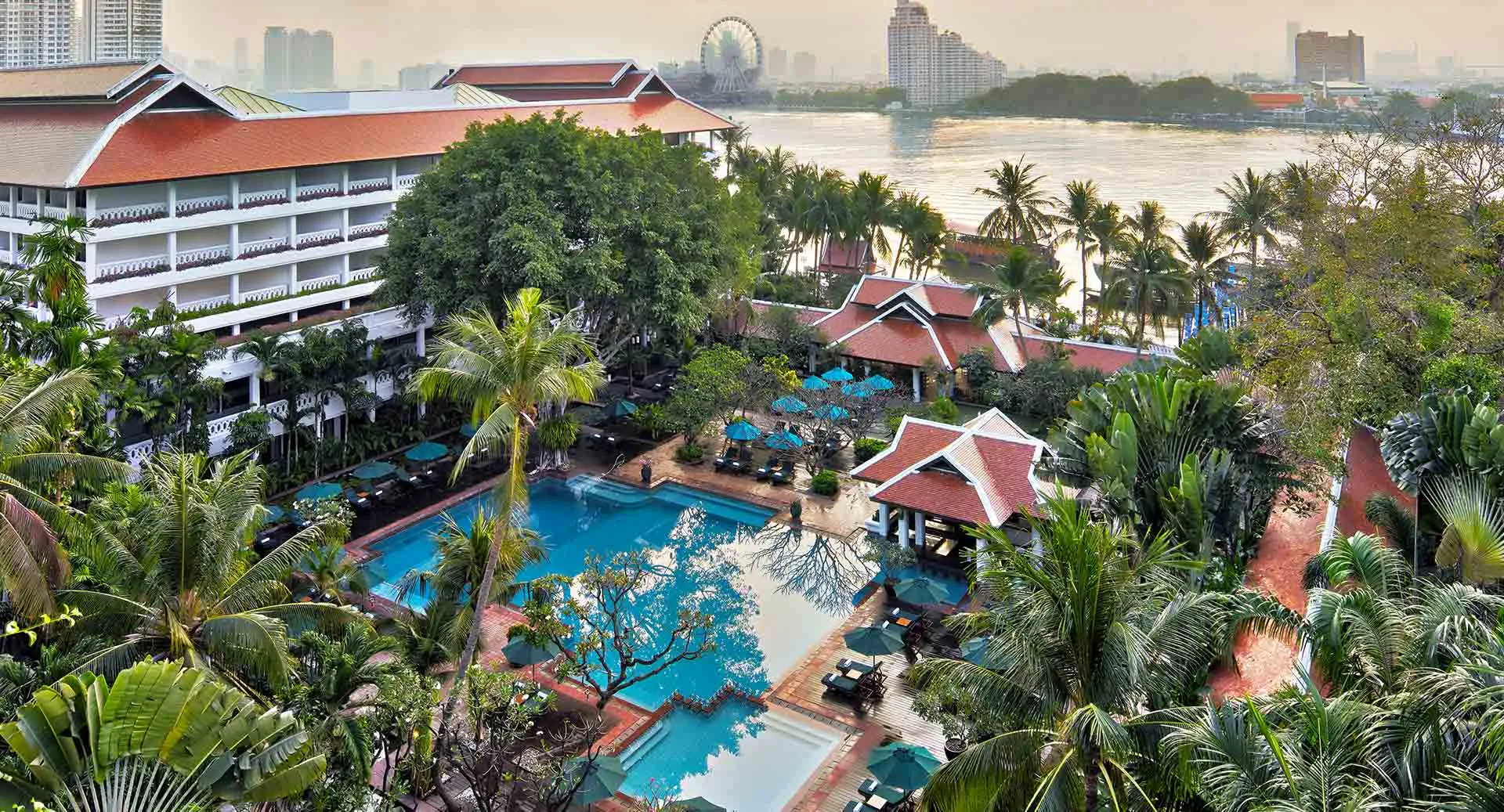 Aerial view of the riverside pool and the Chao Phraya River at golden hour, Anantara Riverside Bangkok Resort