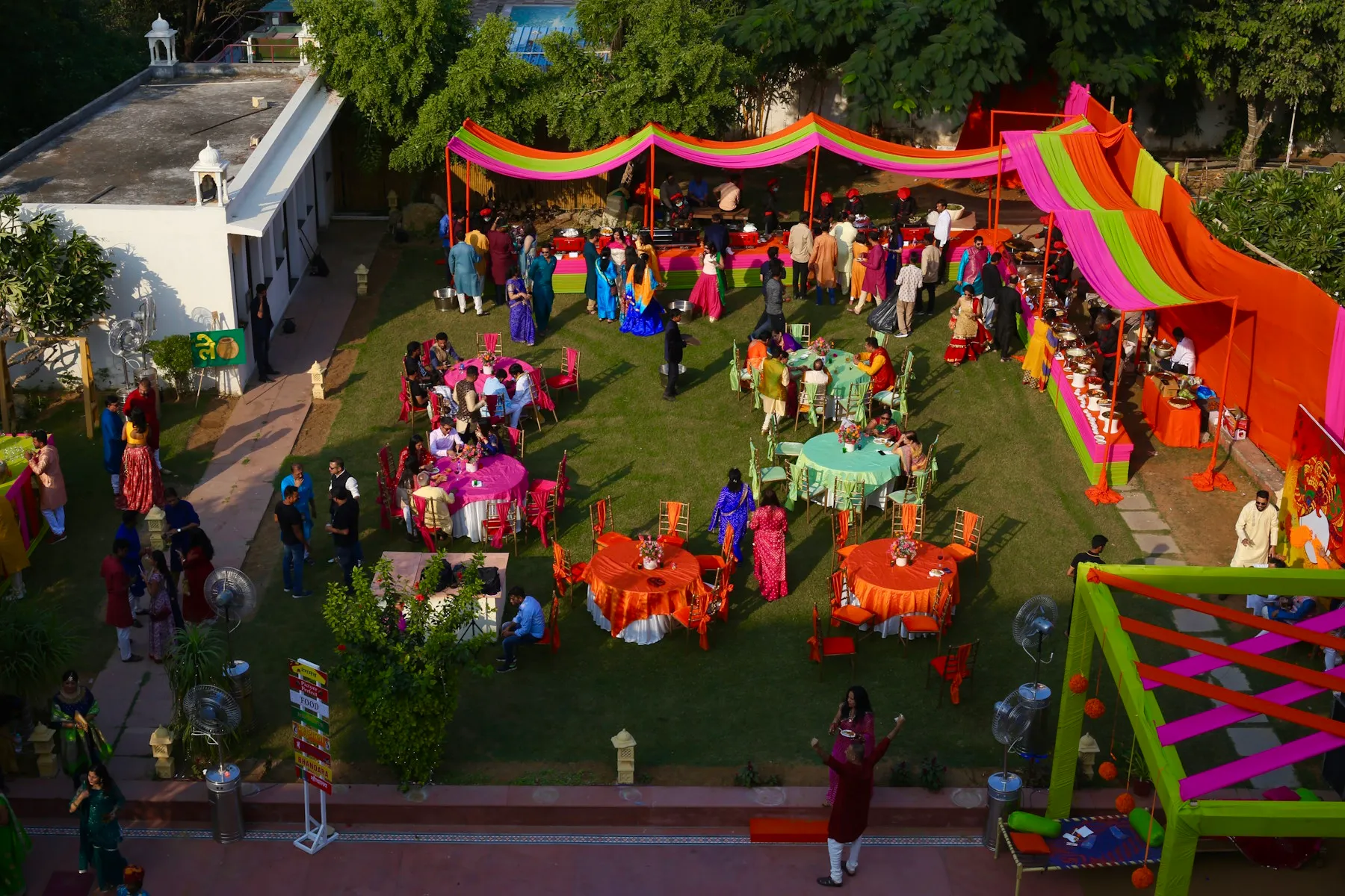 All-white Rajasthani haveli facade and carved arches of Anuraga Palace Ranthambore above green lawns