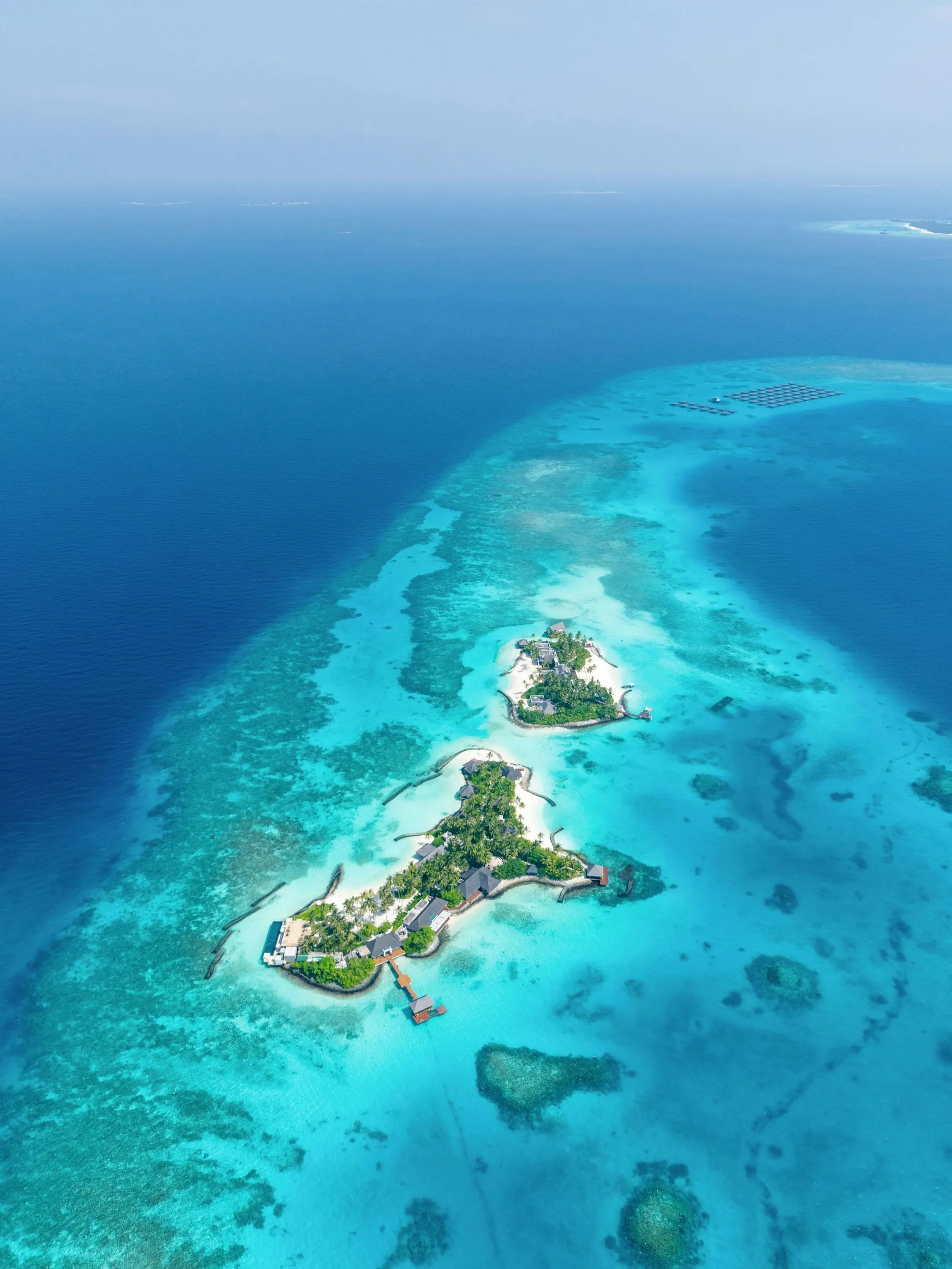 Aerial of Cheval Blanc Randheli five islands and over-water villas in a private lagoon, Maldives