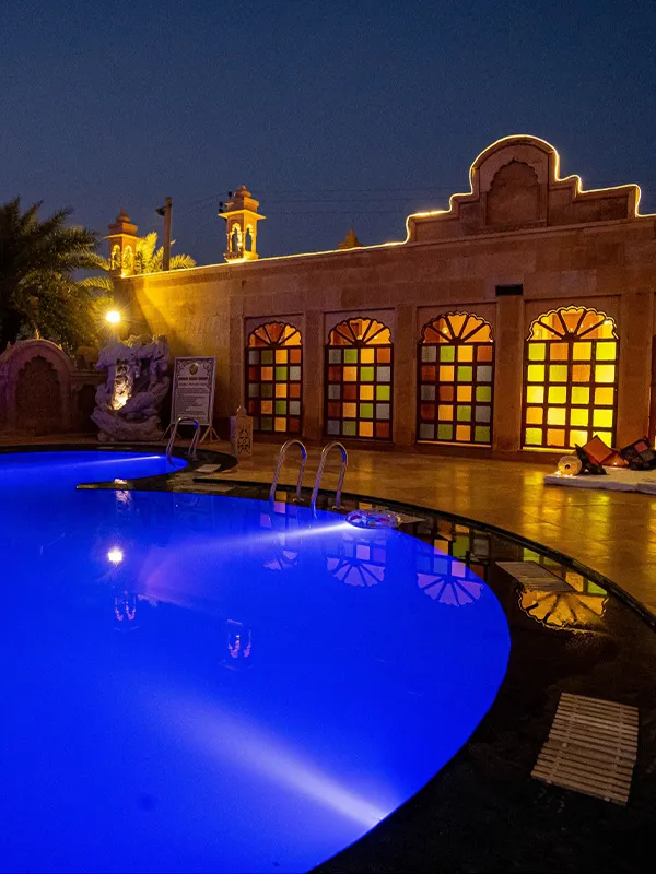 Poolside lawn and Rajasthani-themed central courtyard at Chokhi Dhani The Palace Hotel