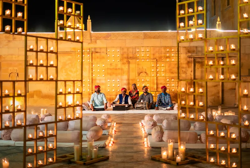 Evening sangeet with Rajasthani folk performers on the lit lawn at Chokhi Dhani The Palace Hotel