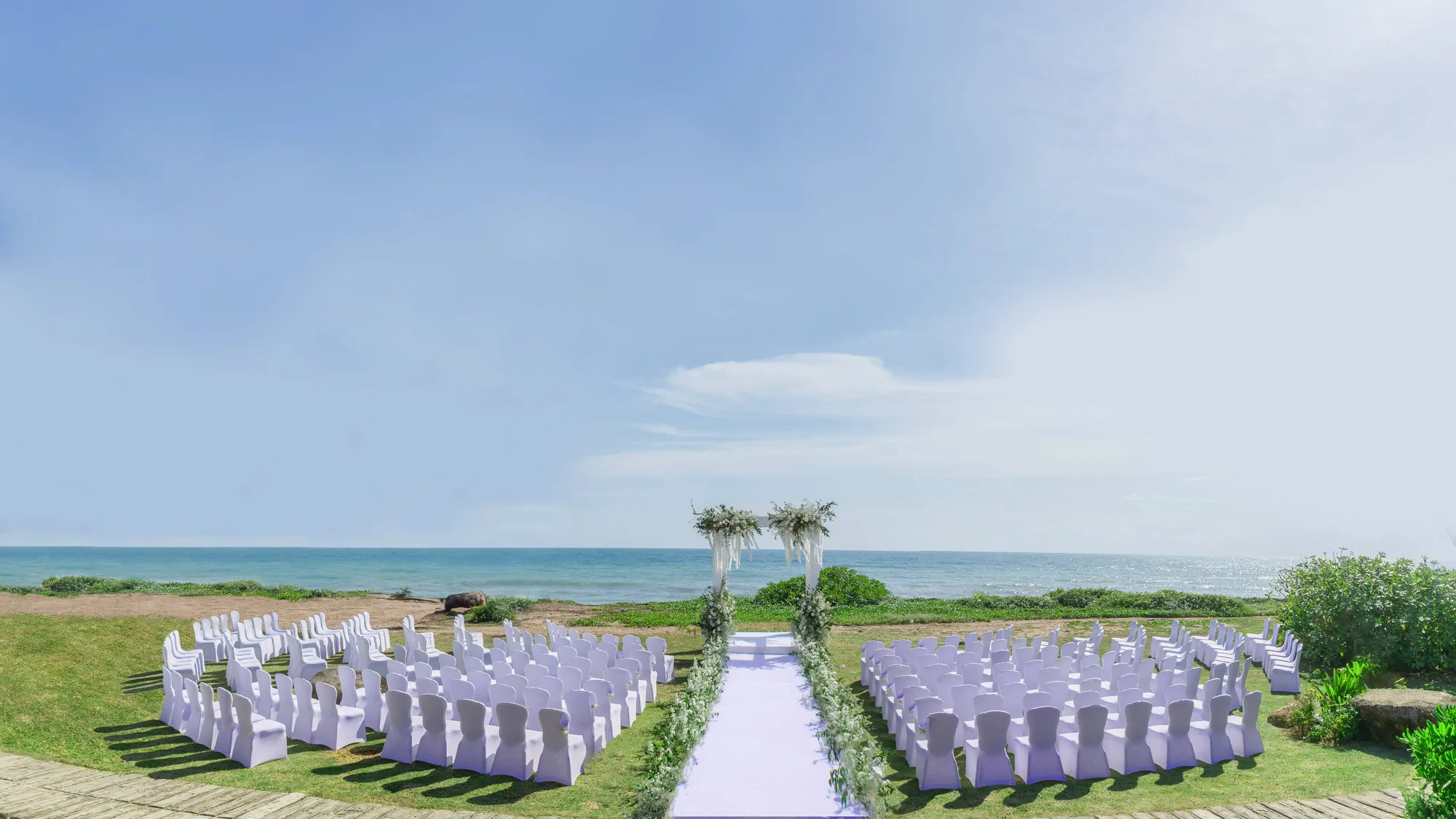 Beachfront wedding ceremony aisle and setup on the sand at JW Marriott Phuket Resort & Spa, Mai Khao