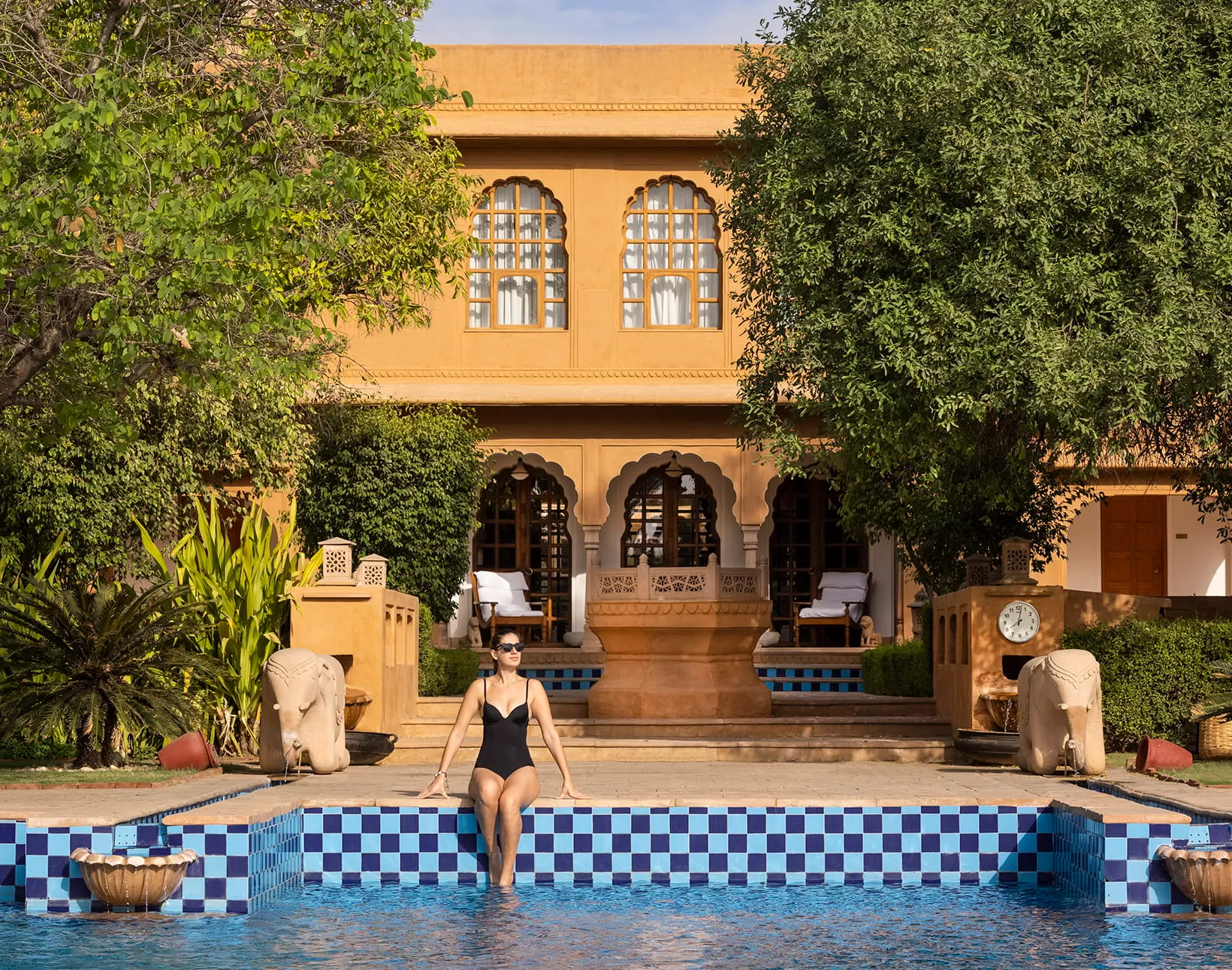 Poolside evening sangeet setting against reflection pools at The Oberoi Rajvilas Jaipur