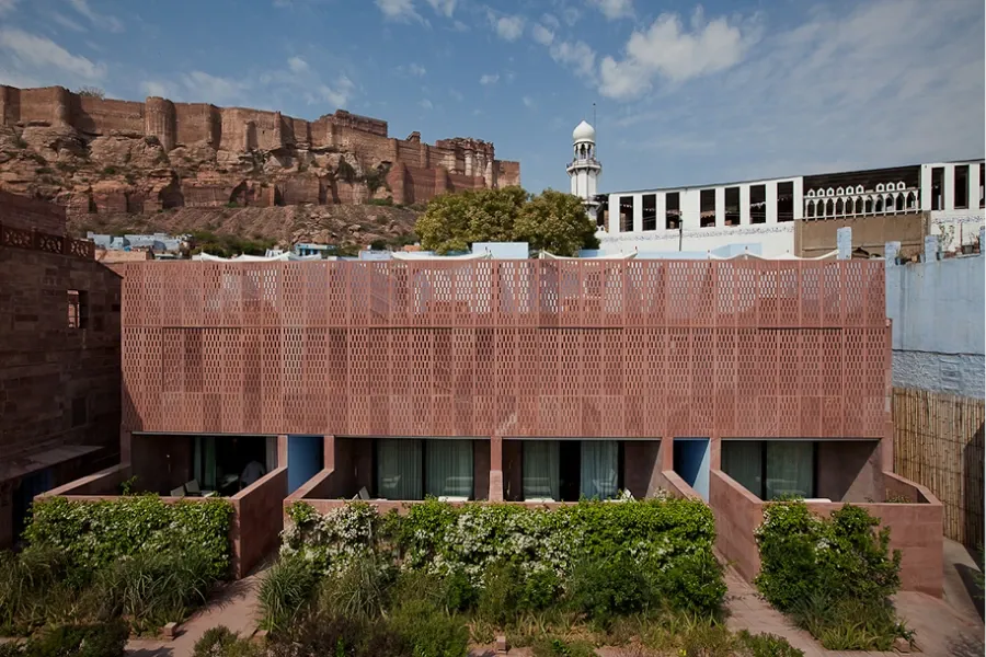 RAAS Jodhpur sandstone haveli architecture with Mehrangarh Fort rising behind it