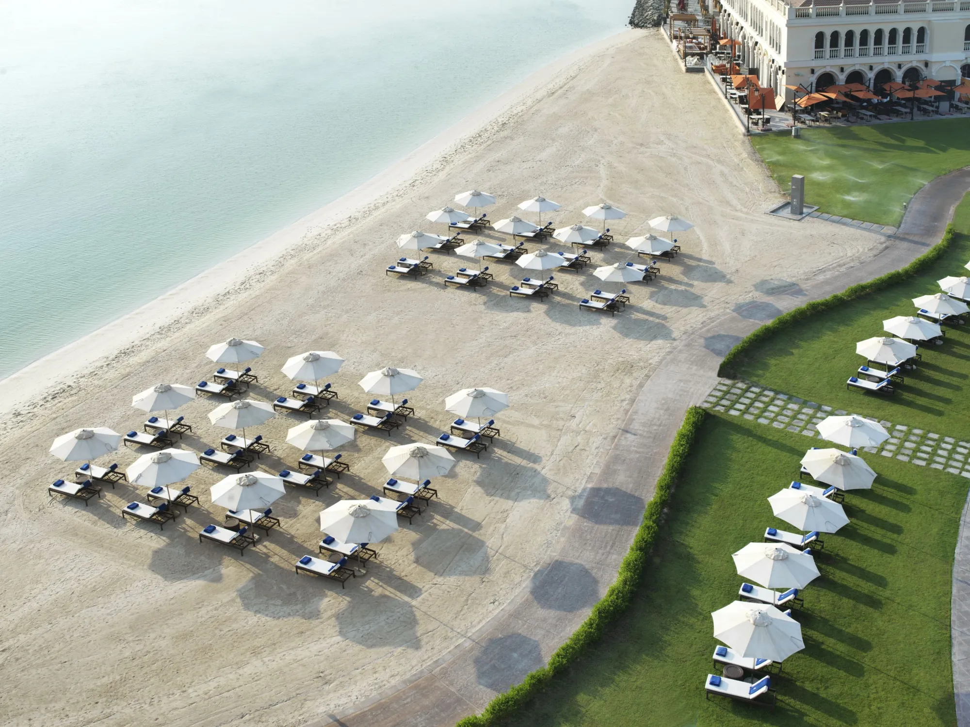 Aerial view of the private beach and Venetian-style resort buildings at The Ritz-Carlton Abu Dhabi Grand Canal