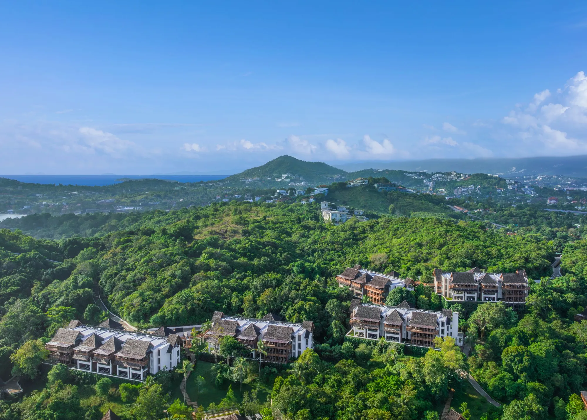 Aerial exterior of The Ritz-Carlton Koh Samui hillside villas in the coconut grove above the Gulf of Thailand