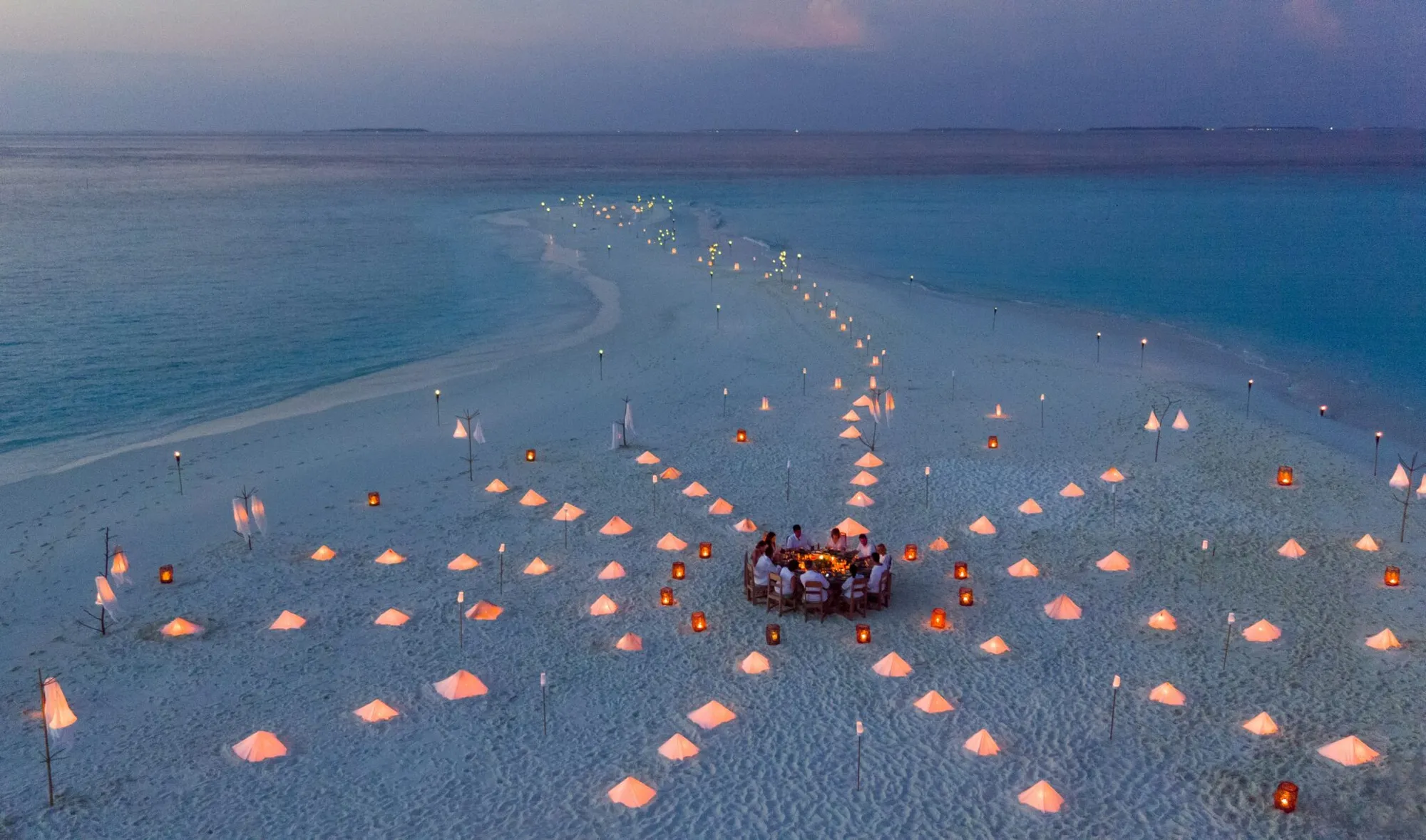 Private sandbank dinner setup under the stars at Soneva Fushi Maldives
