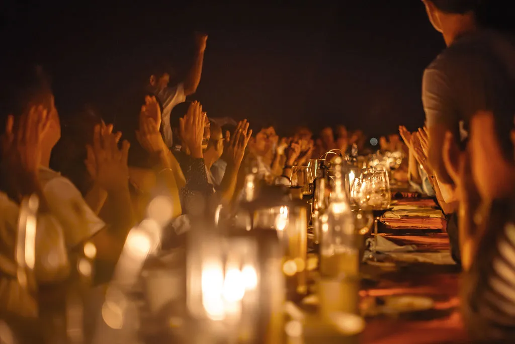 Group celebration dinner on the over-water jetty at Soneva Fushi Maldives