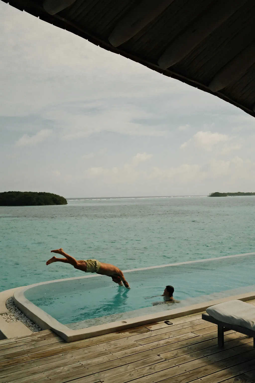 Soneva Fushi private island and lagoon glowing at golden hour in the Baa Atoll, Maldives