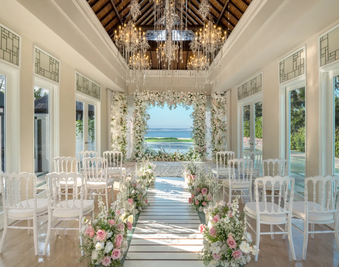 Interior of the glass Cloud Nine Chapel set with a floral arch and ocean view for a ceremony at The St. Regis Bali Resort, Bali