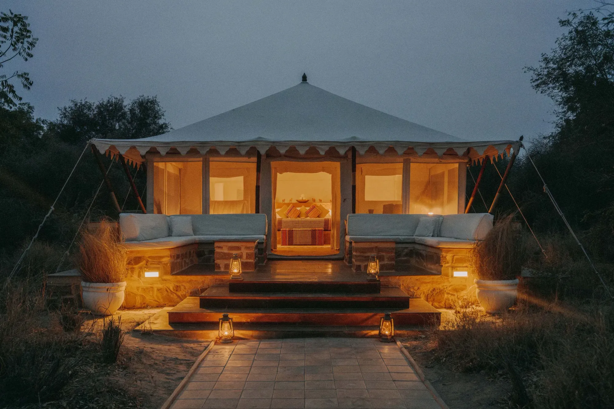 Row of 1920s-inspired luxury safari tents under dhok trees at SUJÁN Sher Bagh Ranthambore